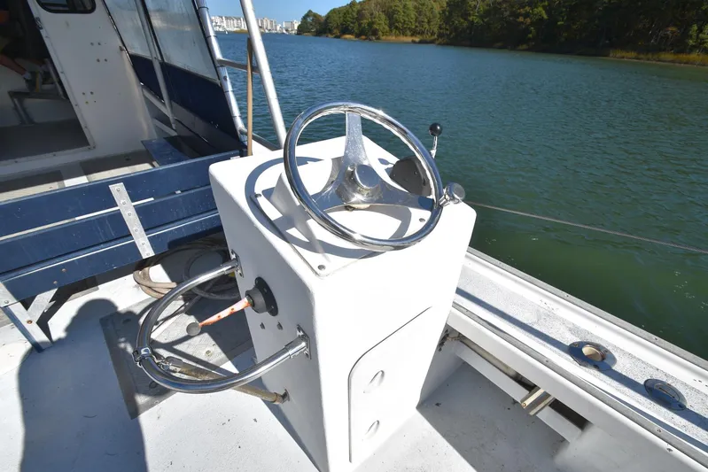 Ocean Explorer Yacht Photos Pics Boat steering console on a 2006 Custom 45 Doucette, near a scenic waterway.
