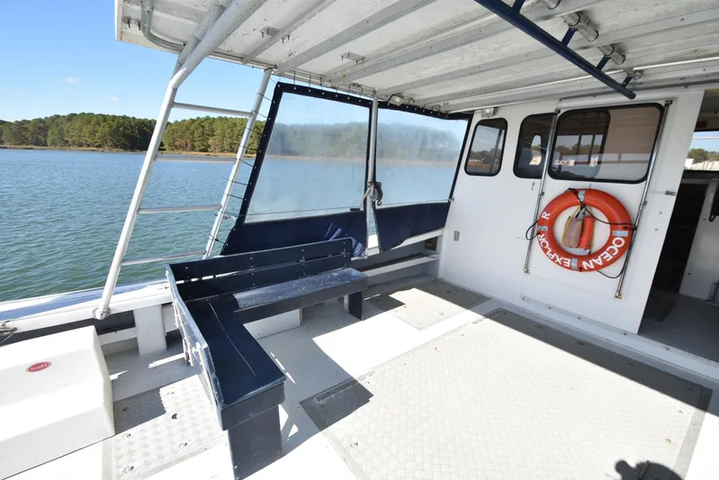 Ocean Explorer Yacht Photos Pics Open deck of 2006 Custom 45 Doucette boat with seating and life preserver.