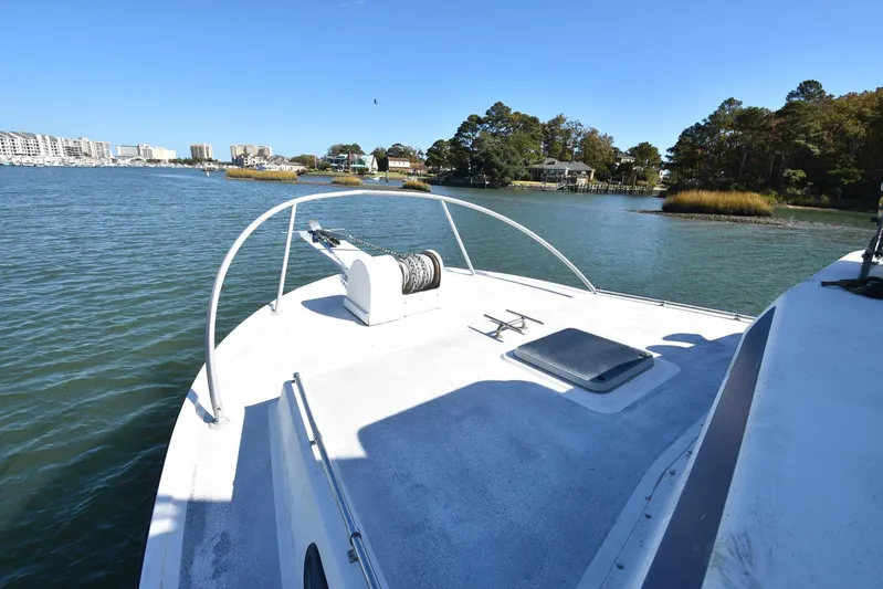 Ocean Explorer Yacht Photos Pics Bow of 2006 Custom 45 Doucette boat on calm water, scenic shoreline view.