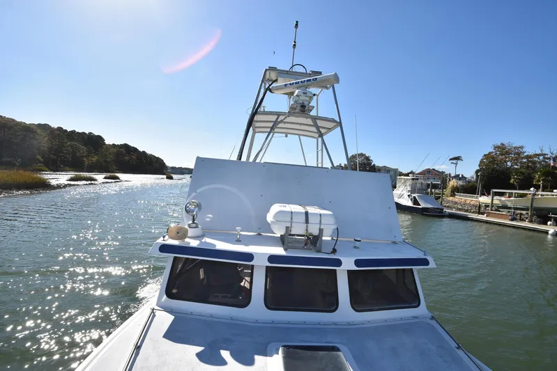 Ocean Explorer Yacht Photos Pics Custom 2006 45 Doucette boat navigating a scenic river under clear blue skies.