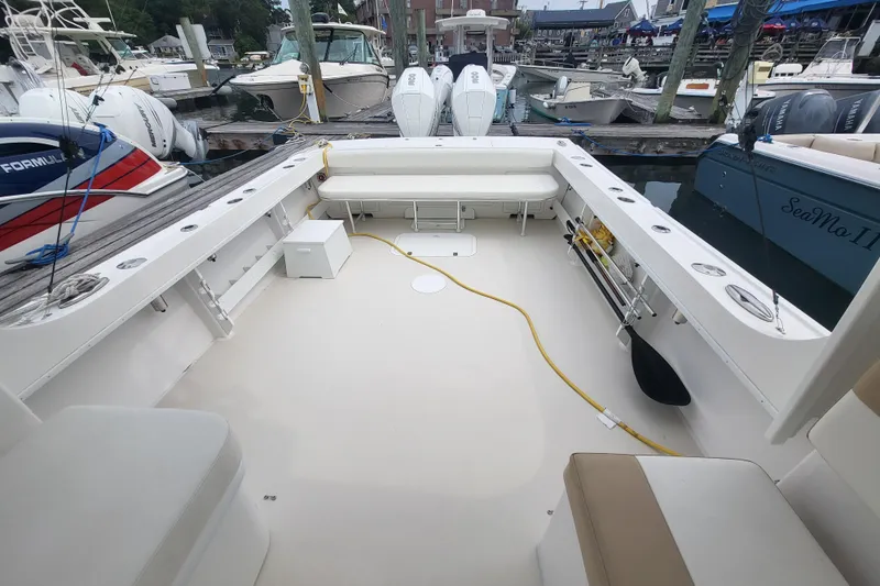  Yacht Photos Pics 2023 Steiger Craft 31 Fisherman boat interior at marina, showcasing spacious deck and seating.