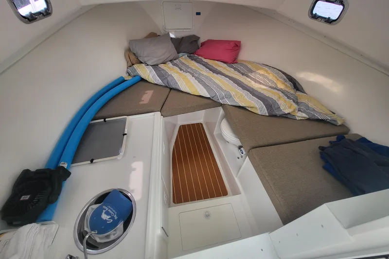  Yacht Photos Pics 2023 Steiger Craft 31 Fisherman cabin interior with cozy bedding and seating.