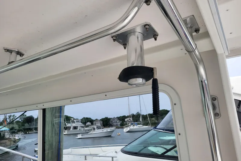  Yacht Photos Pics Interior view of 2023 Steiger Craft 31 Fisherman boat with metal fixtures and marina background.