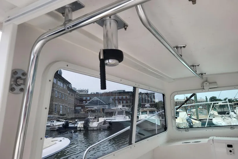  Yacht Photos Pics Interior view of 2023 Steiger Craft 31 Fisherman boat in a marina setting.