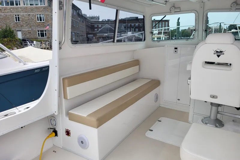  Yacht Photos Pics Interior of 2023 Steiger Craft 31 Fisherman boat with seating and helm chair.