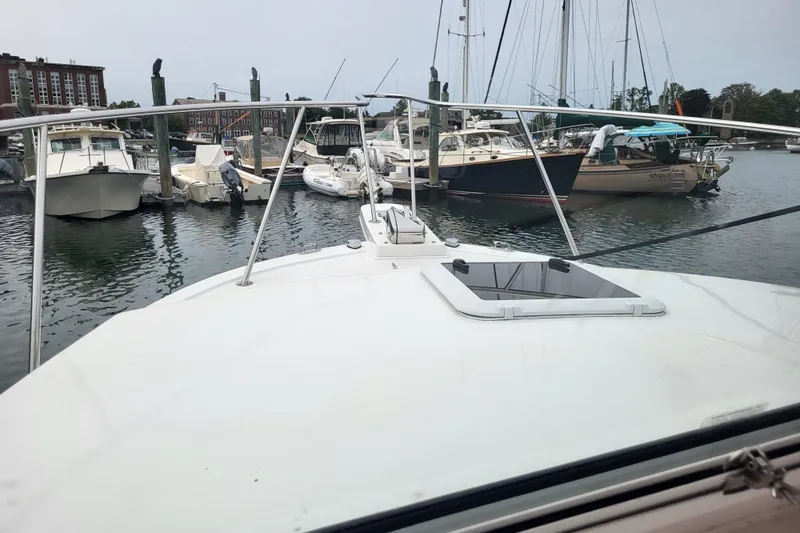  Yacht Photos Pics 2023 Steiger Craft 31 Fisherman docked among various boats in a marina.