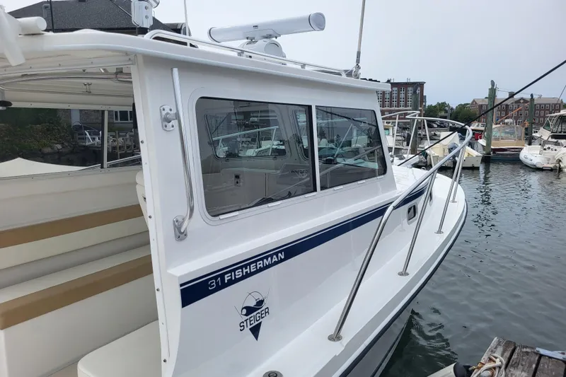  Yacht Photos Pics 2023 Steiger Craft 31 Fisherman boat docked in a marina.