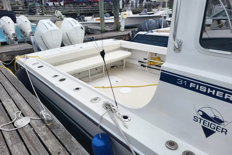  Yacht Photos Pics 2023 Steiger Craft 31 Fisherman boat docked with outboard engines.