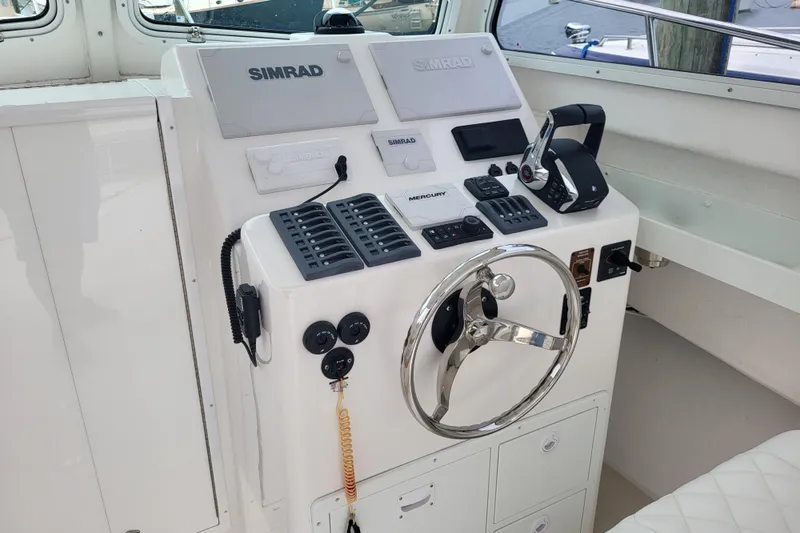  Yacht Photos Pics 2023 Steiger Craft 31 Fisherman helm with Simrad electronics and steering wheel.