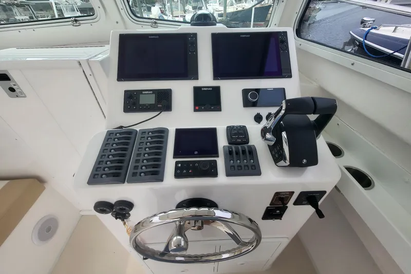  Yacht Photos Pics 2023 Steiger Craft 31 Fisherman helm with advanced navigation controls and dual Simrad displays.