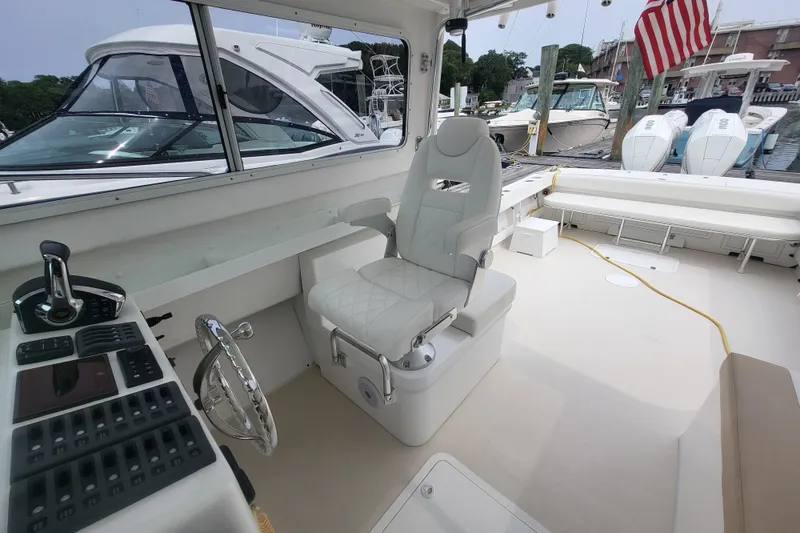  Yacht Photos Pics 2023 Steiger Craft 31 Fisherman boat interior with helm, seating, and docked view.