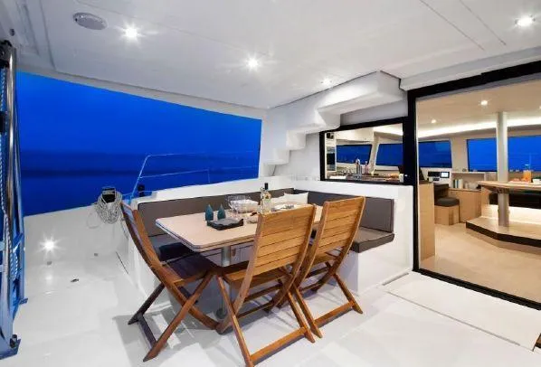Raiatea Yacht Photos Pics Luxurious Bali 4.5 yacht interior with dining area, wooden chairs, and modern design, 2015 model.