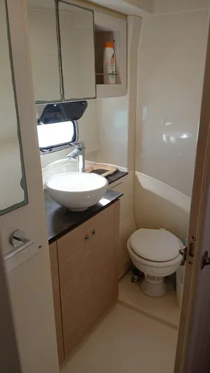 Raiatea Yacht Photos Pics Compact bathroom in a 2015 Bali 4.5 model, featuring a sink, toilet, and storage.