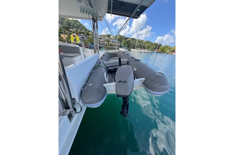 Raiatea Yacht Photos Pics Inflatable boat on a 2015 Bali 4.5 catamaran, docked in a scenic marina.