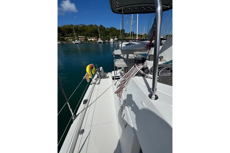 Raiatea Yacht Photos Pics 2015 Bali 4.5 catamaran deck with ropes, docked in a serene marina.