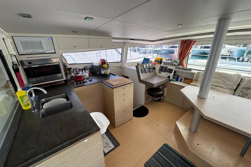 Raiatea Yacht Photos Pics Interior of a 2015 Bali 4.5 catamaran with kitchen and navigation area.