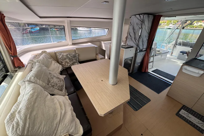 Raiatea Yacht Photos Pics Luxurious interior of 2015 Bali 4.5 catamaran with cozy seating and scenic water view.