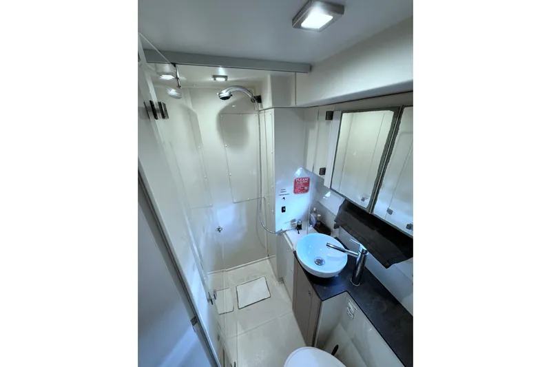 Raiatea Yacht Photos Pics Modern bathroom interior in 2015 Bali 4.5 model yacht, featuring shower and sleek sink design.