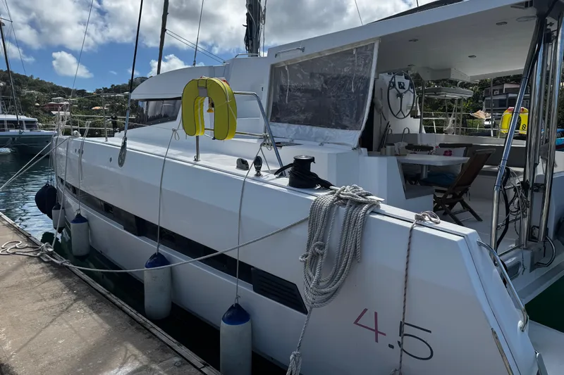 Raiatea Yacht Photos Pics Bali 4.5 catamaran docked at marina, showcasing spacious deck and modern design.