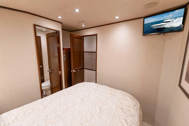 The Provider Yacht Photos Pics Bedroom interior of 2015 Viking 76 Convertible yacht with TV and ensuite bathroom.
