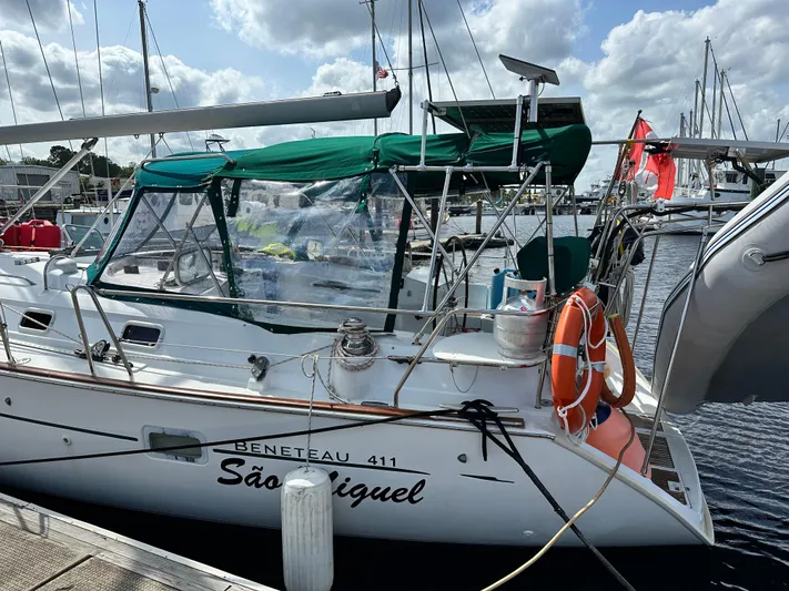 Sao Miguel Yacht Photos Pics Beneteau Oceanis 40 sailboat docked, featuring green canopy and lifebuoy, year 2000 model.