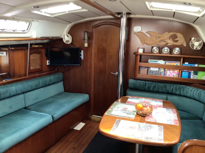 Sao Miguel Yacht Photos Pics Interior of 2000 Beneteau Oceanis 40 yacht with cozy seating and wooden decor.