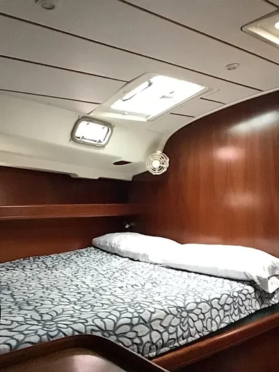 Sao Miguel Yacht Photos Pics Cozy cabin interior of 2000 Beneteau Oceanis 40 sailboat with wooden finish and bedding.