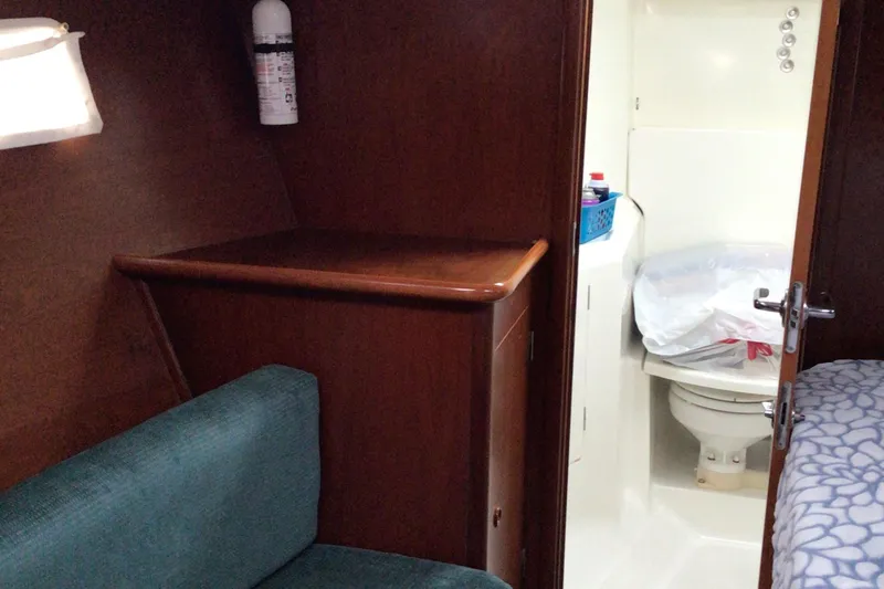 Sao Miguel Yacht Photos Pics Interior of 2000 Beneteau Oceanis 40 yacht showing bathroom and seating area.