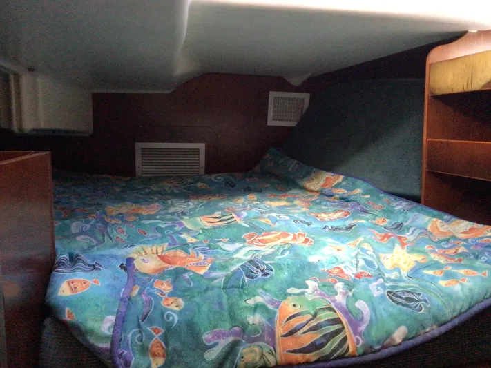 Sao Miguel Yacht Photos Pics Cozy cabin interior of 2000 Beneteau Oceanis 40 with colorful fish-themed bedding.