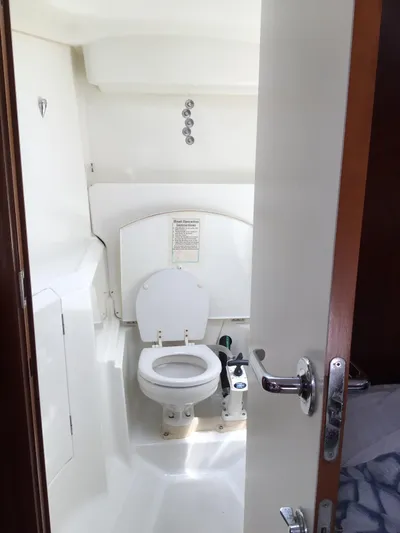 Sao Miguel Yacht Photos Pics Beneteau Oceanis 40 (2000) yacht bathroom with white marine toilet and compact design.