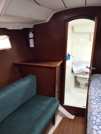 Sao Miguel Yacht Photos Pics Interior of 2000 Beneteau Oceanis 40 yacht, featuring a cozy cabin and compact bathroom.