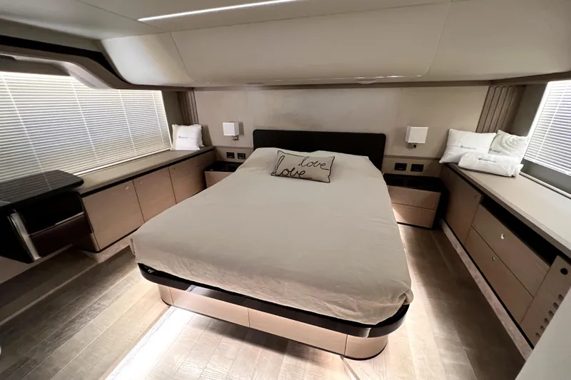 Skyfall Yacht Photos Pics Luxurious bedroom interior of 2022 Absolute 52 Navetta yacht with modern design and cozy bedding.