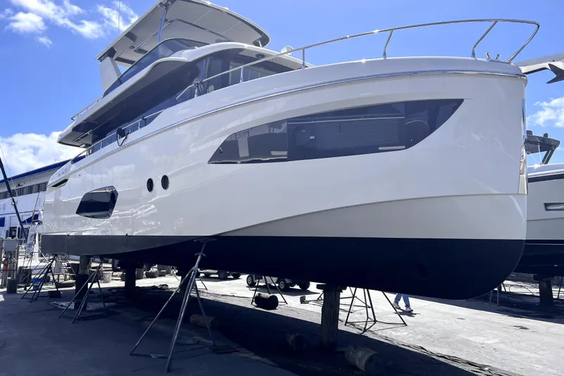 Skyfall Yacht Photos Pics 2022 Absolute 52 Navetta yacht on dry dock under clear blue sky.
