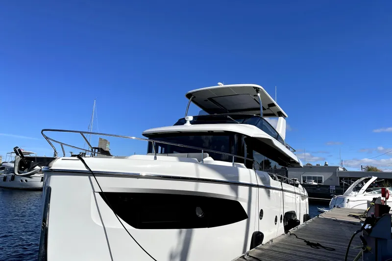 Skyfall Yacht Photos Pics Luxury 2022 Absolute 52 Navetta yacht docked under clear blue sky.
