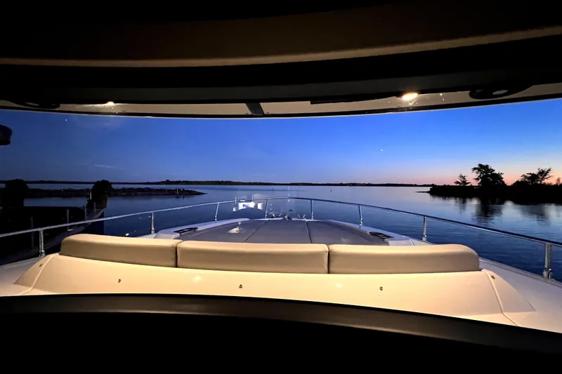 Skyfall Yacht Photos Pics Luxurious 2022 Absolute 52 Navetta yacht at sunset, serene water view.