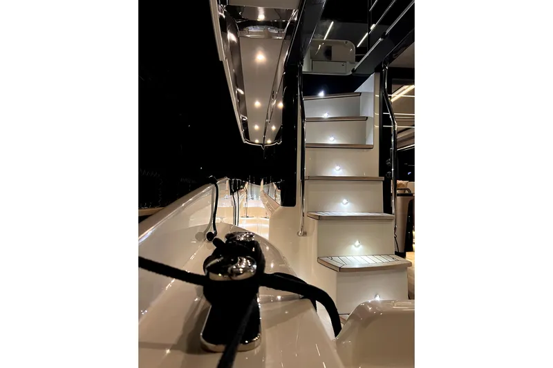 Skyfall Yacht Photos Pics Luxurious 2022 Absolute 52 Navetta yacht with illuminated stairs and sleek design.