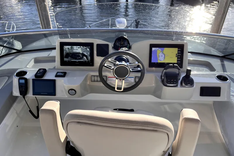 Skyfall Yacht Photos Pics Cockpit of 2022 Absolute 52 Navetta yacht with modern navigation equipment and steering wheel.