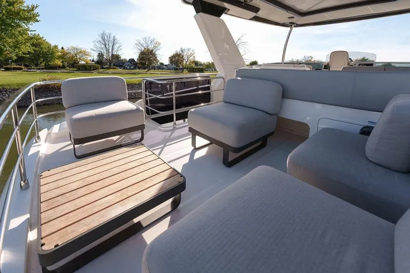 Skyfall Yacht Photos Pics Luxurious seating area on 2022 Absolute 52 Navetta yacht, featuring modern outdoor furniture.