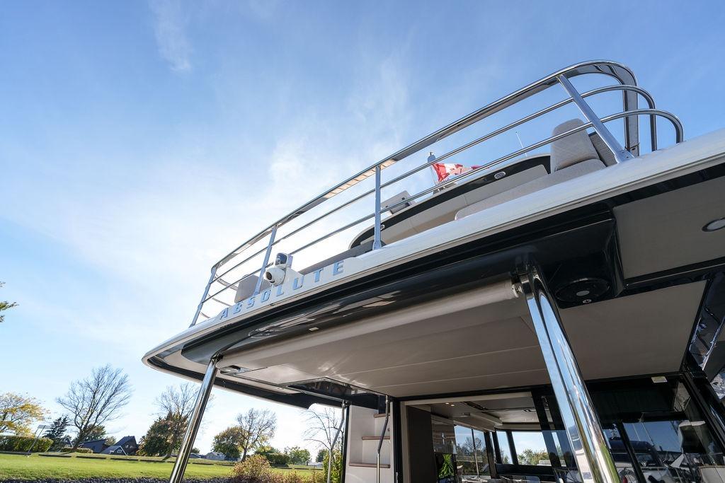 2022 Absolute 52 Navetta yacht, showcasing sleek design and modern architecture under a clear sky.