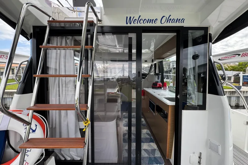  Yacht Photos Pics 2022 Jeanneau NC Weekender 1095 boat interior with stairs and kitchen area.