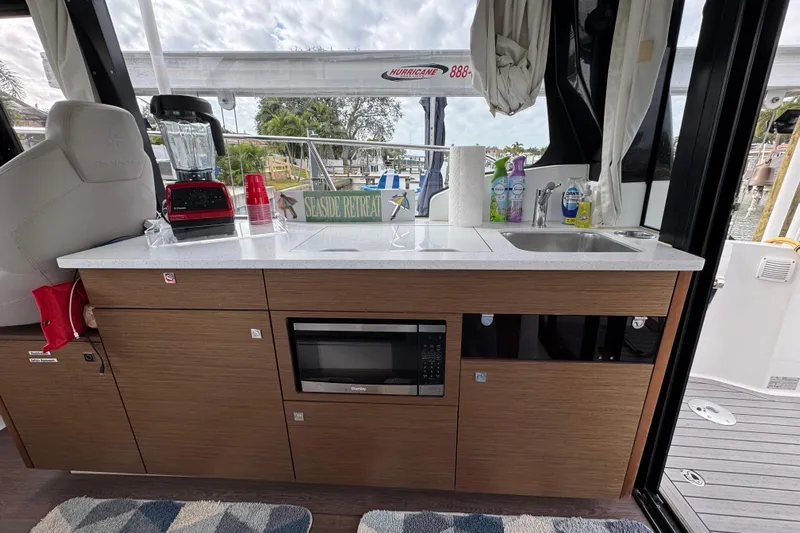  Yacht Photos Pics Interior of 2022 Jeanneau NC Weekender 1095 with kitchenette and appliances.
