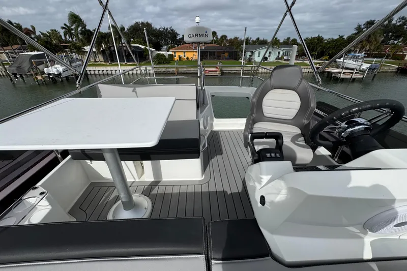  Yacht Photos Pics 2022 Jeanneau NC Weekender 1095 boat interior with seating and steering area.