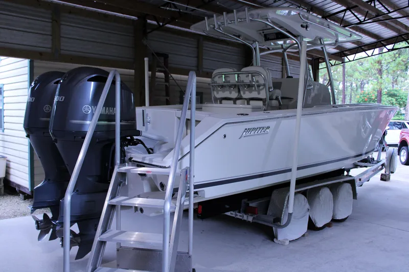  Yacht Photos Pics 2017 Jupiter 30 HFS boat with dual Yamaha engines in a covered storage area.