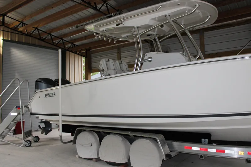 Yacht Photos Pics 2017 Jupiter 30 HFS boat in storage, side view with trailer and cover.