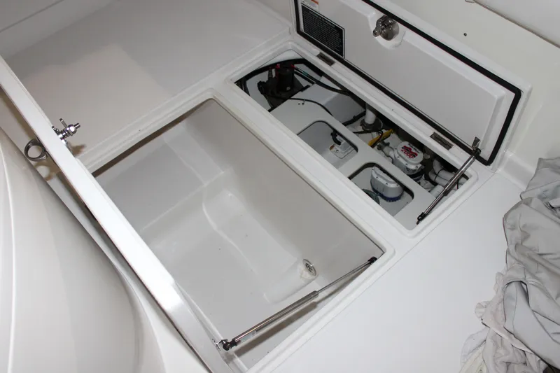  Yacht Photos Pics Open storage compartments on a 2017 Jupiter 30 HFS boat, showcasing interior details.