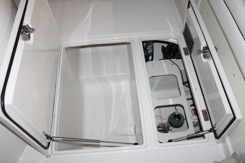  Yacht Photos Pics Open storage compartments on a 2017 Jupiter 30 HFS boat, showcasing interior details.