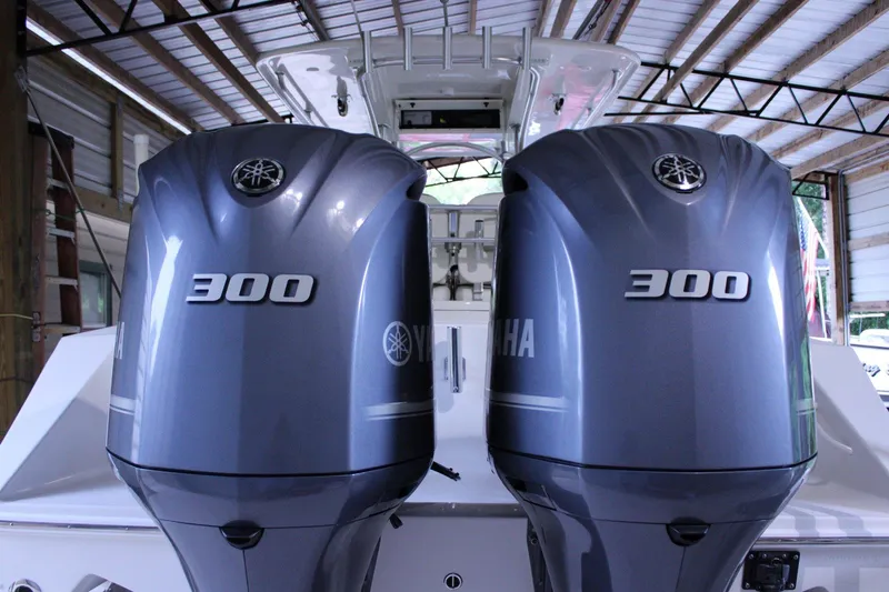  Yacht Photos Pics Twin Yamaha 300 engines on a 2017 Jupiter 30 HFS boat in a covered dock.