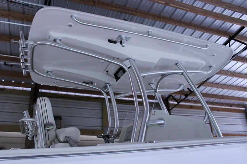  Yacht Photos Pics 2017 Jupiter 30 HFS boat with T-top and rod holders in a covered storage area.