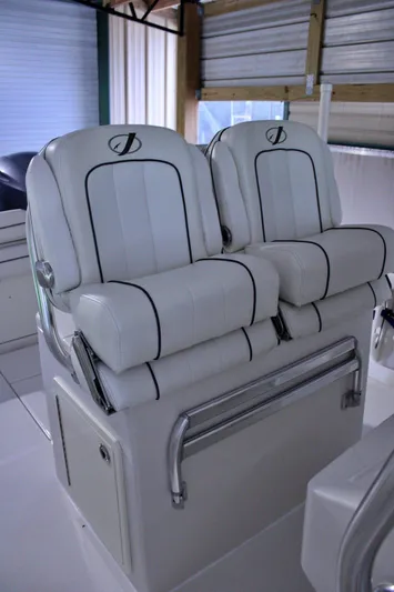  Yacht Photos Pics 2017 Jupiter 30 HFS boat seats, white leather with black accents, in a covered area.