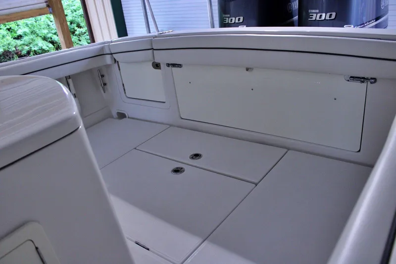  Yacht Photos Pics Interior view of a 2017 Jupiter 30 HFS boat, showcasing storage compartments and seating area.